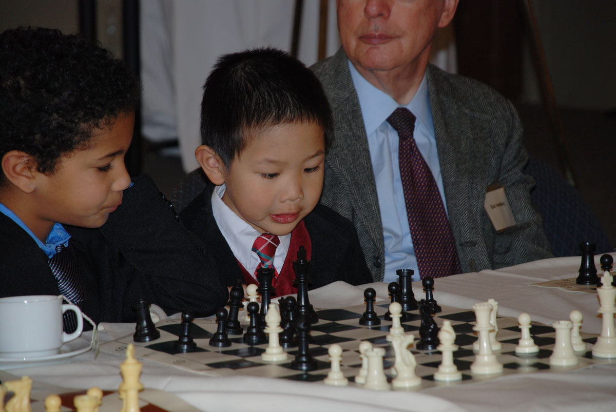 Boy playing chess at the Big Chair Chess Club